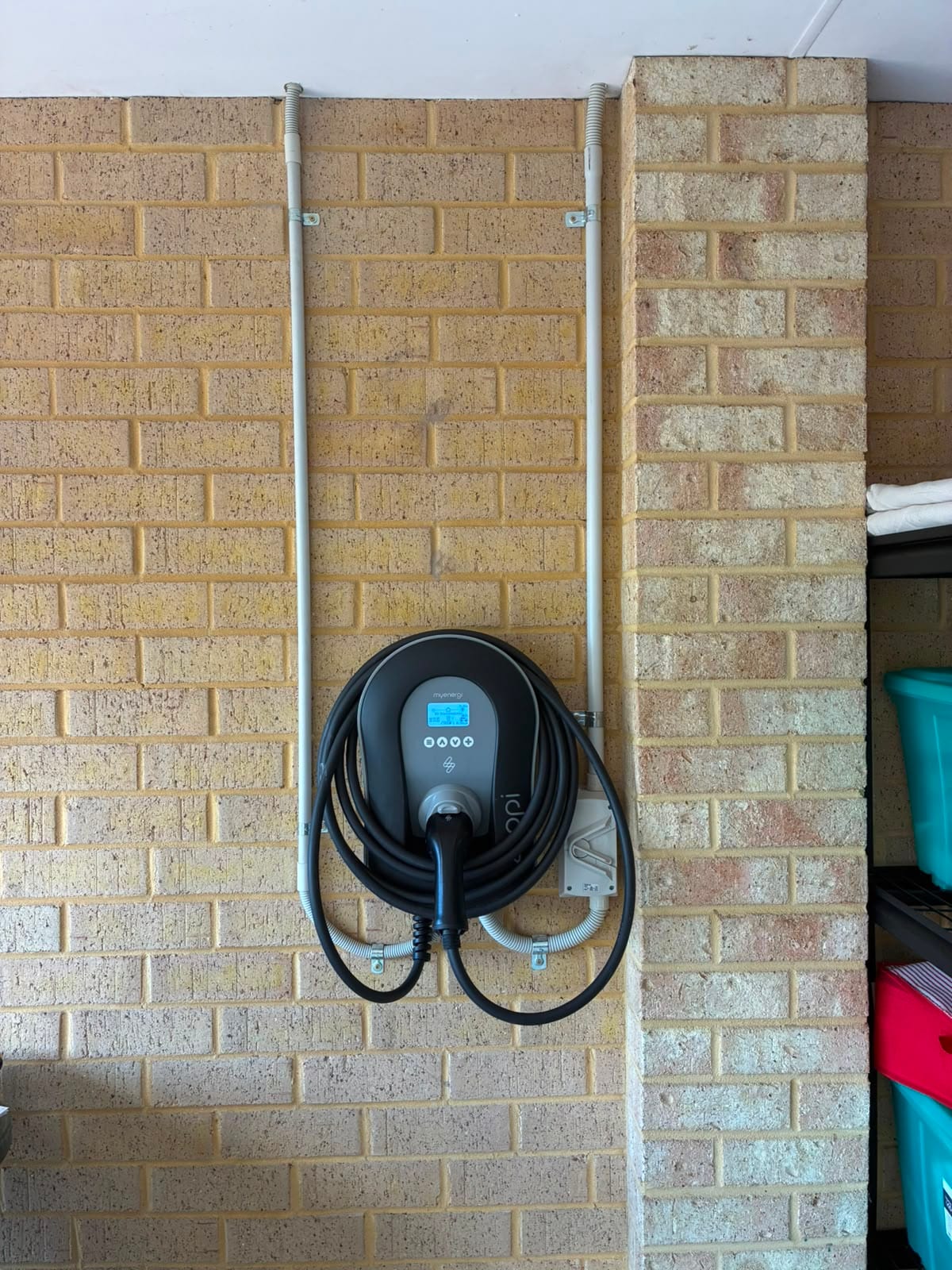 Wall-mounted home EV charger installed by JEC