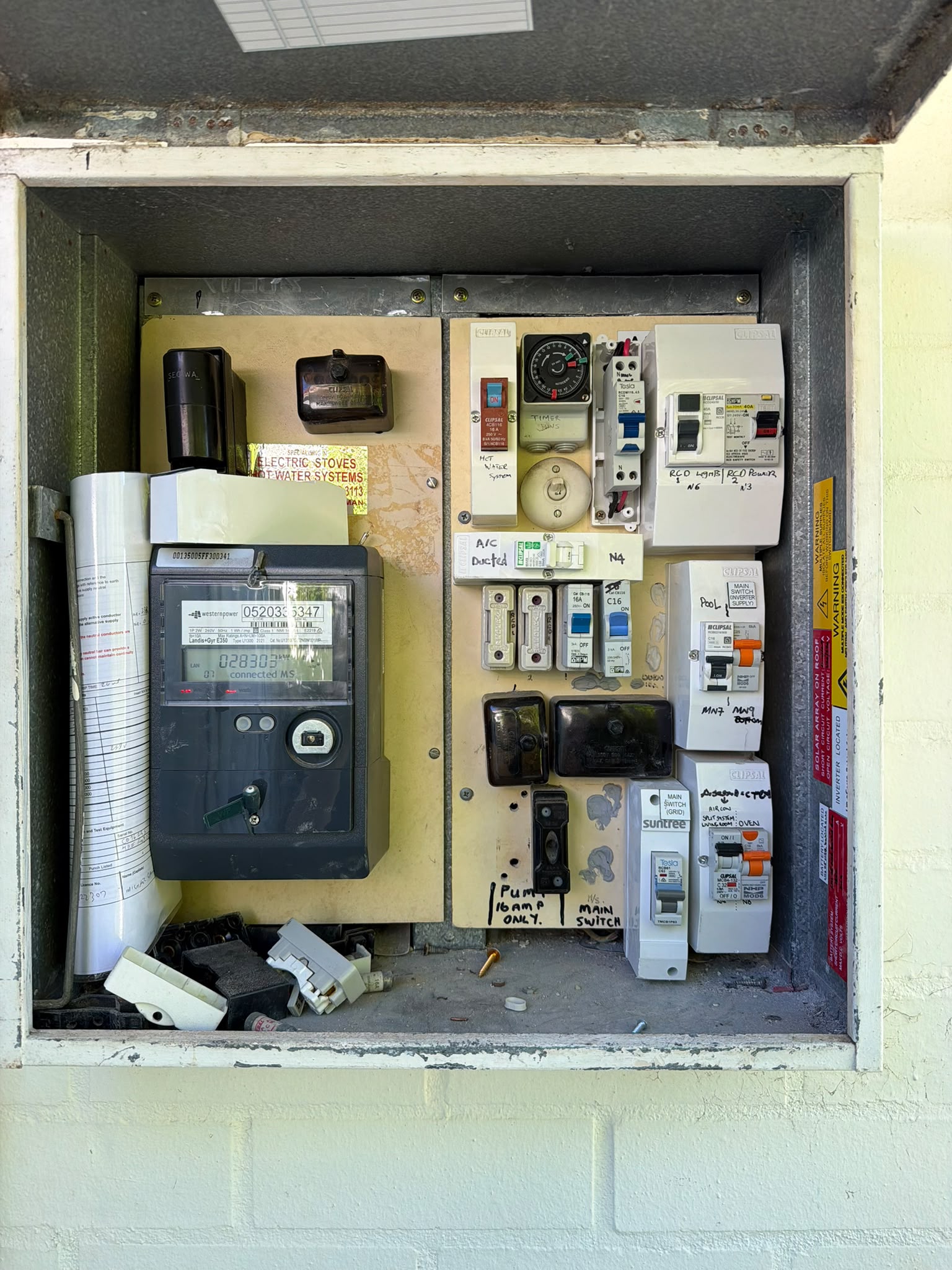 Residential switchboard before JEC replaced the old mixed fuse and breaker setup
